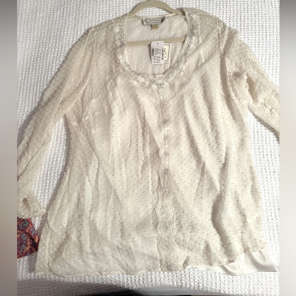 Elegantly detailed breezy tunic. Includes silk slip and sheer Swiss dot overlay